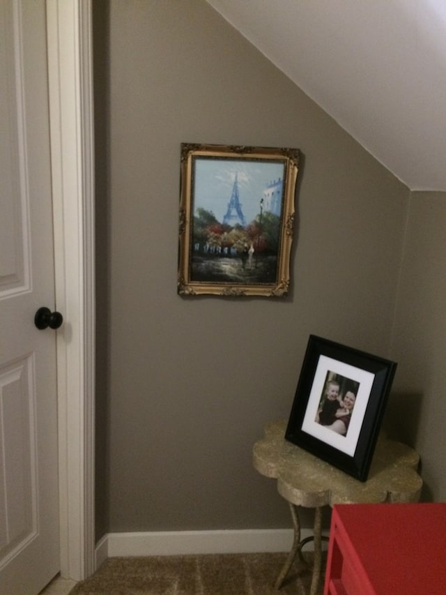 interior space featuring vaulted ceiling and baseboards