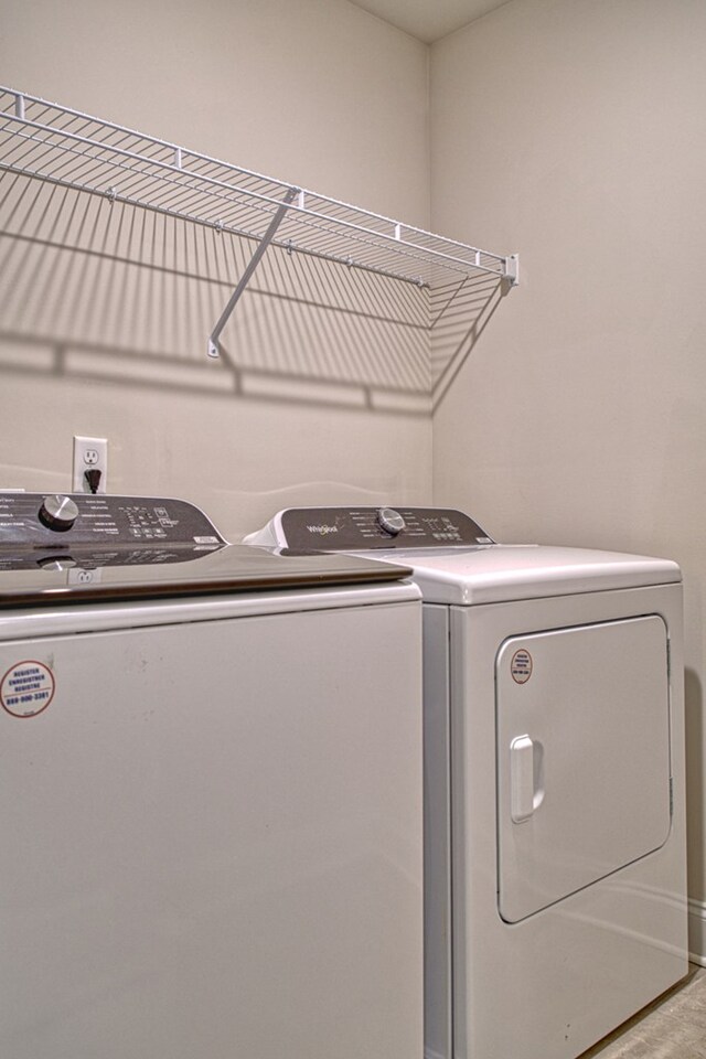 laundry area featuring washer and dryer, laundry area, and baseboards