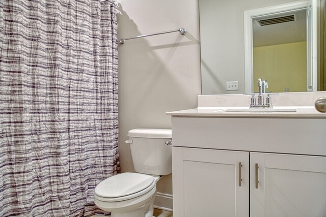 bathroom with visible vents, vanity, and toilet