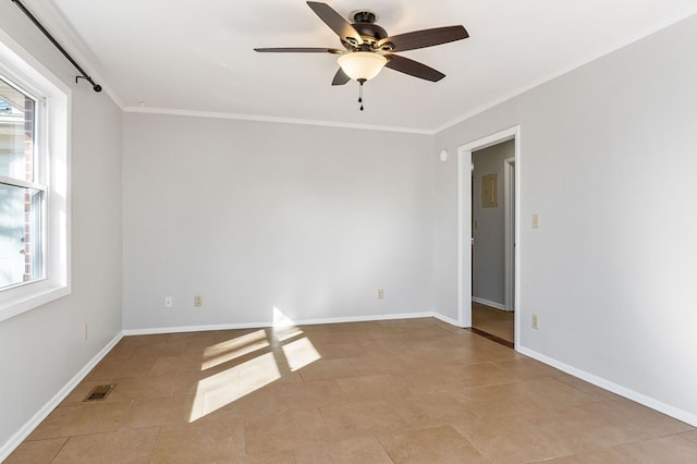 empty room with visible vents, crown molding, baseboards, and ceiling fan