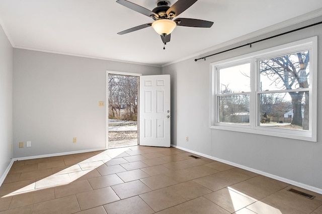 empty room featuring ornamental molding, tile patterned flooring, visible vents, and baseboards