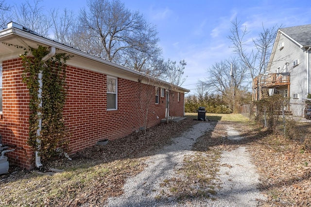 view of side of home featuring brick siding