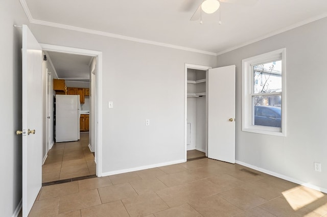 unfurnished bedroom featuring a ceiling fan, baseboards, ornamental molding, a closet, and freestanding refrigerator