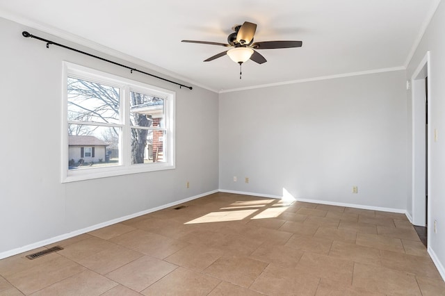 spare room with ornamental molding, visible vents, and baseboards