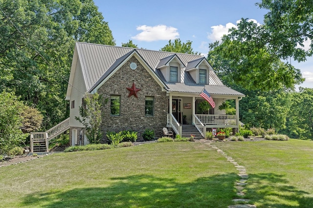 view of front of home featuring stone siding, metal roof, a front lawn, and a porch