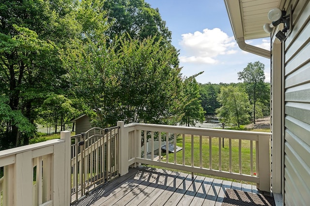 wooden terrace featuring a lawn