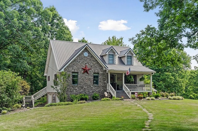 view of front of home with stone siding, covered porch, a front lawn, and stairs