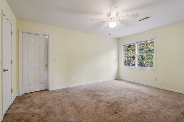 unfurnished room featuring a ceiling fan, carpet, visible vents, and baseboards