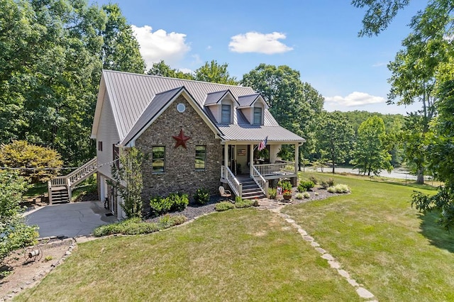 view of front of home featuring a front yard, covered porch, driveway, and stairs