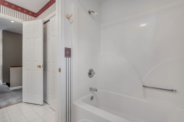 full bathroom featuring a textured ceiling, shower / bathtub combination, baseboards, and wallpapered walls