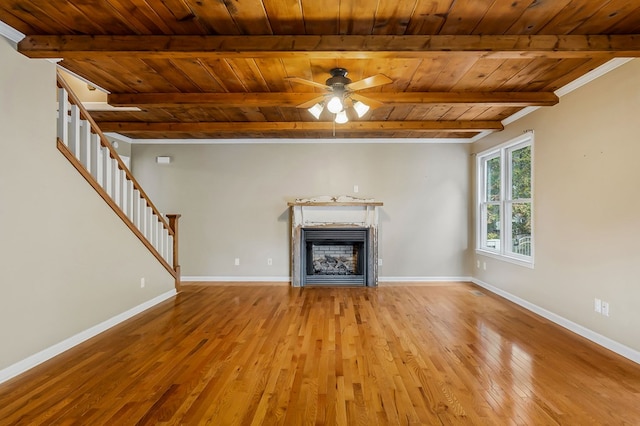 unfurnished living room with light wood-type flooring, a fireplace, stairway, and baseboards