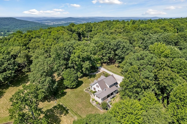 birds eye view of property with a mountain view and a forest view