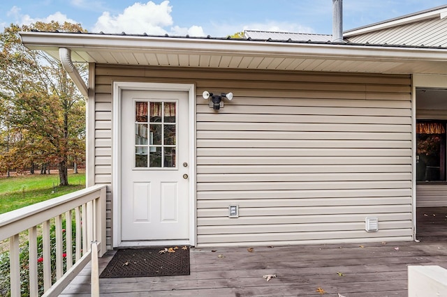 view of exterior entry with a deck