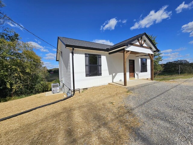 back of property with a shingled roof