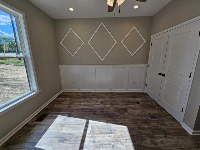 unfurnished room featuring visible vents, a decorative wall, dark wood-type flooring, and recessed lighting