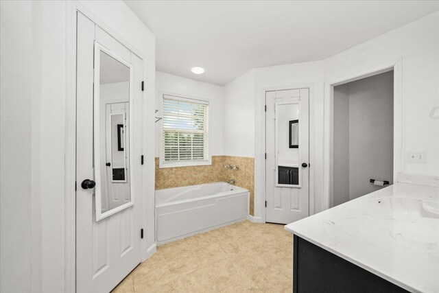 bathroom with a bath and vanity