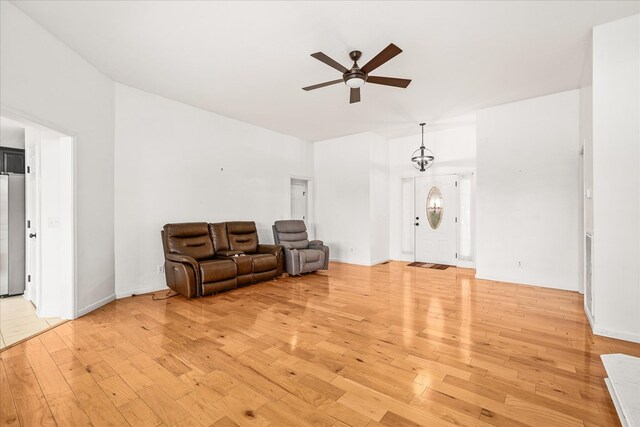 sitting room with a ceiling fan and light wood-style floors