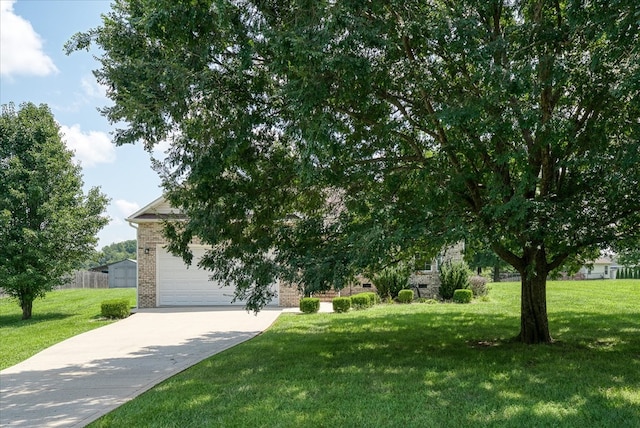 obstructed view of property featuring an attached garage, a front lawn, concrete driveway, and brick siding