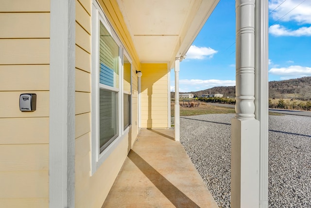 exterior space featuring covered porch and a mountain view