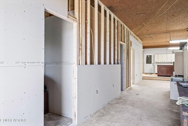 hallway featuring unfinished concrete flooring