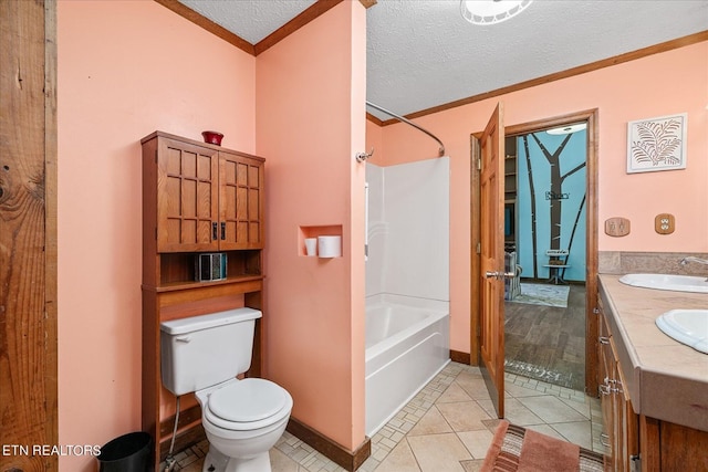 bathroom featuring double vanity, toilet, crown molding, a textured ceiling, and a sink