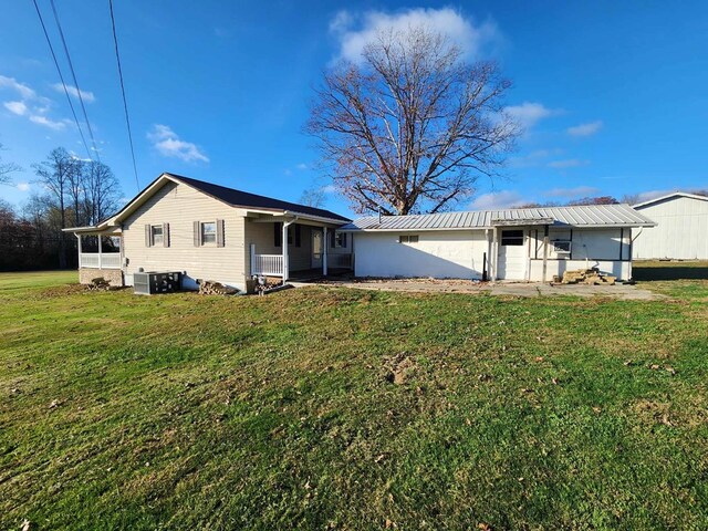 back of property featuring a yard