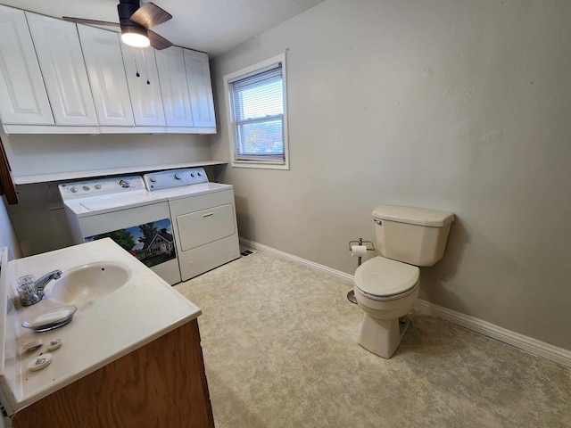 bathroom with washer and clothes dryer, toilet, ceiling fan, vanity, and baseboards