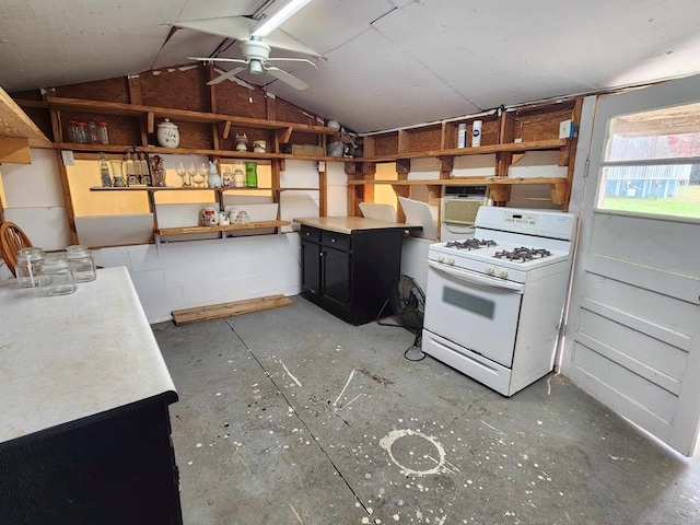 kitchen featuring vaulted ceiling, ceiling fan, dark cabinetry, and white gas range oven