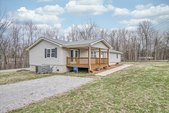 view of front of home featuring a porch, crawl space, metal roof, cooling unit, and a front lawn