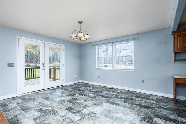 unfurnished dining area with a notable chandelier, french doors, and baseboards