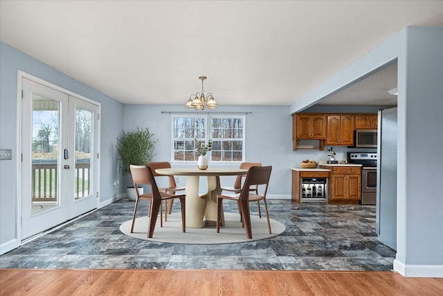 dining area with wine cooler, french doors, dark wood finished floors, and an inviting chandelier