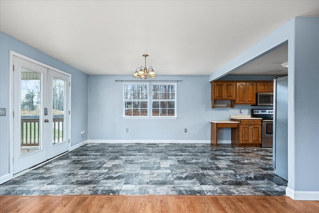 kitchen featuring appliances with stainless steel finishes, french doors, brown cabinetry, and dark wood finished floors