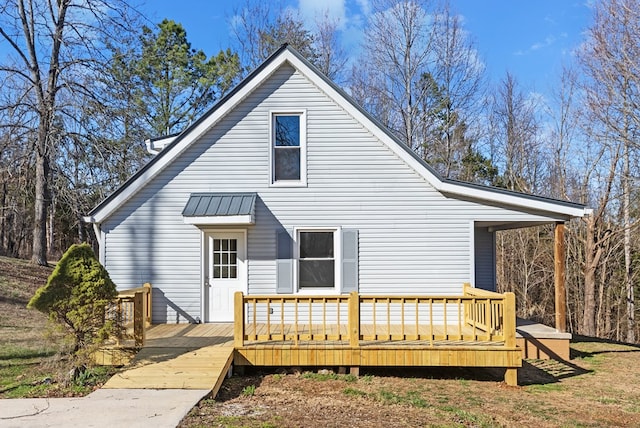 back of house with a deck