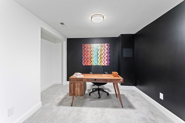 carpeted office space with visible vents and baseboards