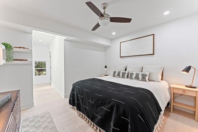 bedroom featuring baseboards, light wood finished floors, a ceiling fan, and recessed lighting