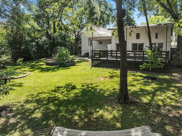 view of yard featuring a garden and a wooden deck