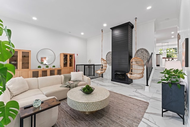 living area with a large fireplace, marble finish floor, crown molding, and recessed lighting