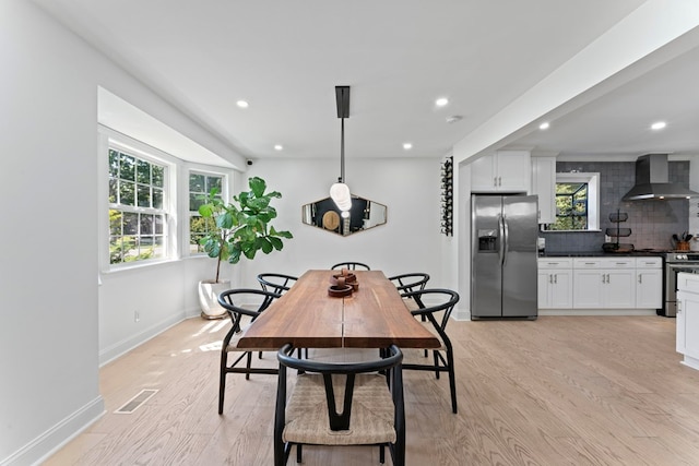 dining space with light wood-type flooring, visible vents, baseboards, and recessed lighting