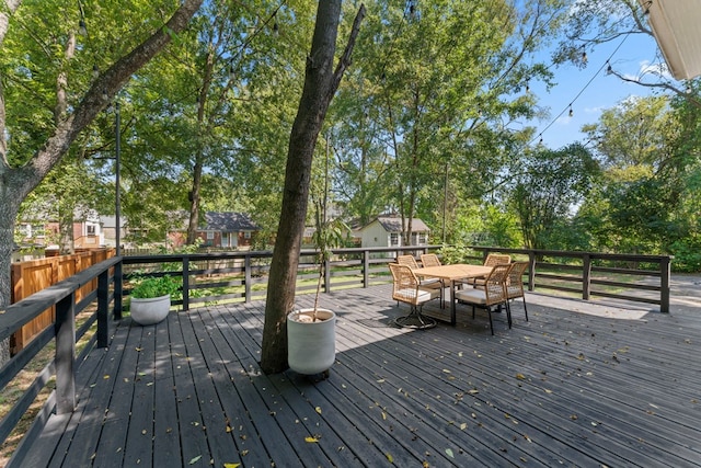 wooden deck featuring outdoor dining space and fence