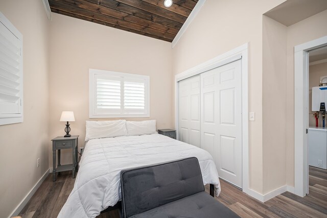 bedroom with wooden ceiling, baseboards, vaulted ceiling, a closet, and dark wood-style floors