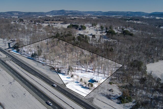 snowy aerial view with a mountain view