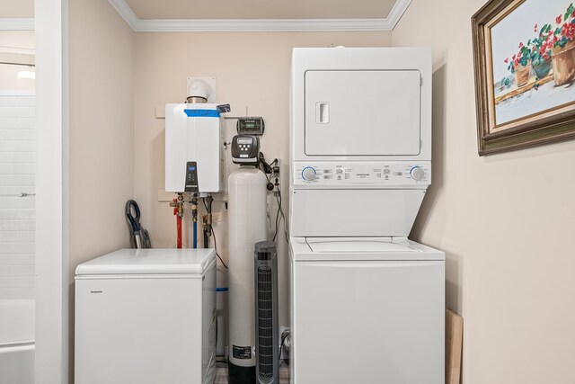 laundry area with laundry area, crown molding, and stacked washing maching and dryer