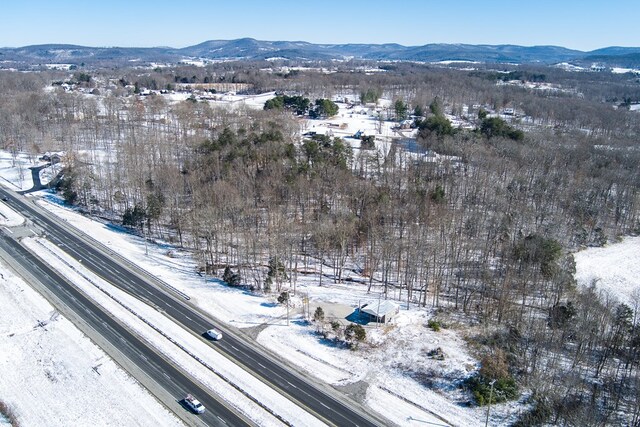 snowy aerial view with a mountain view