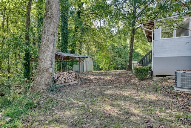 view of yard with cooling unit and an outdoor structure