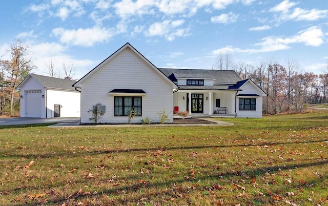 modern farmhouse style home with a garage, covered porch, and a front lawn