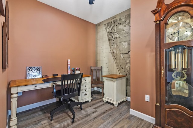 home office with dark wood-style floors and baseboards