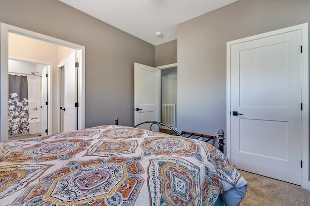 bedroom with light carpet, connected bathroom, and visible vents