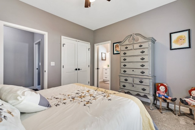 carpeted bedroom featuring ensuite bathroom, a closet, a ceiling fan, and baseboards