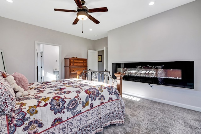 bedroom featuring baseboards, a ceiling fan, carpet flooring, a multi sided fireplace, and recessed lighting