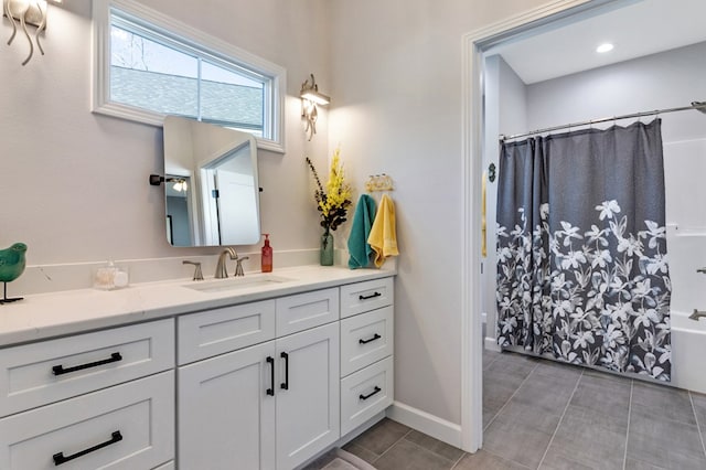 full bath featuring tile patterned flooring, baseboards, shower / bath combo with shower curtain, and vanity